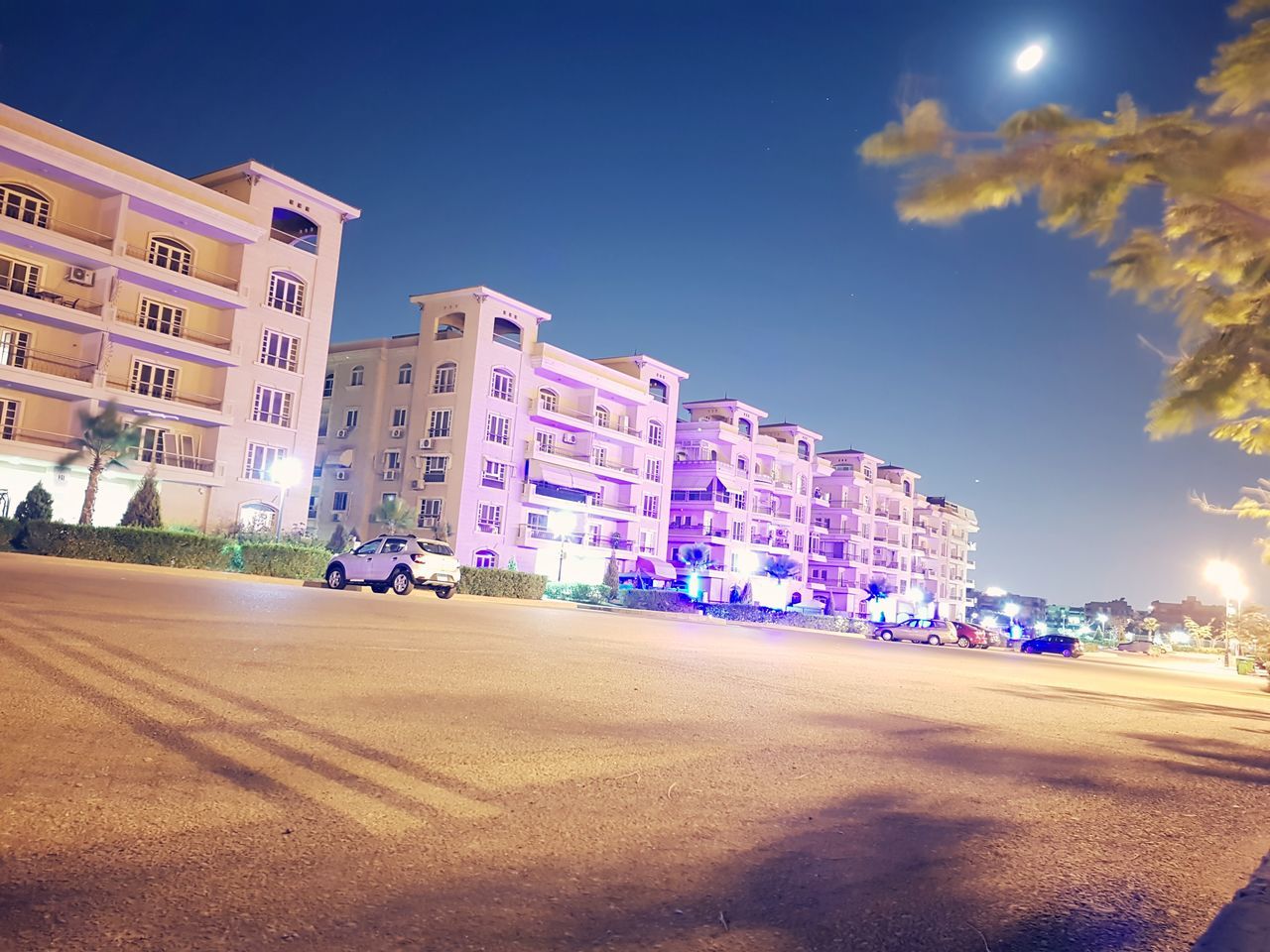 building exterior, architecture, built structure, car, sky, outdoors, city, road, illuminated, no people, tree, day