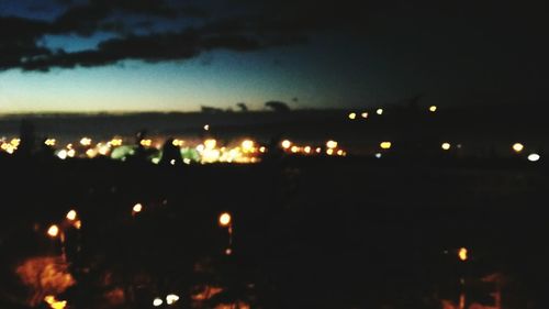 Illuminated trees against sky at night