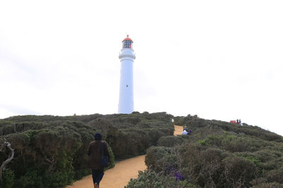 Lighthouse on mountain against clear sky
