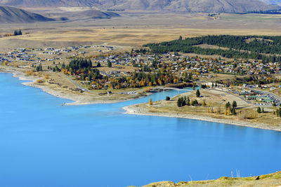 High angle view of lake and buildings against sky