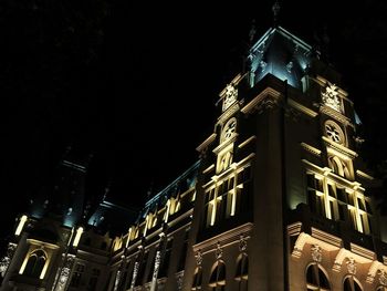 Low angle view of illuminated buildings at night