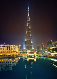 Illuminated buildings in city at night