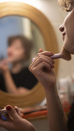 Side view of woman using mobile phone