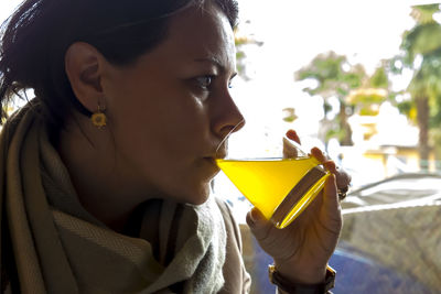 Close-up of woman having drink