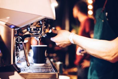 Midsection of man working in cafe