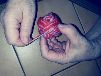 High angle view of hand holding baby