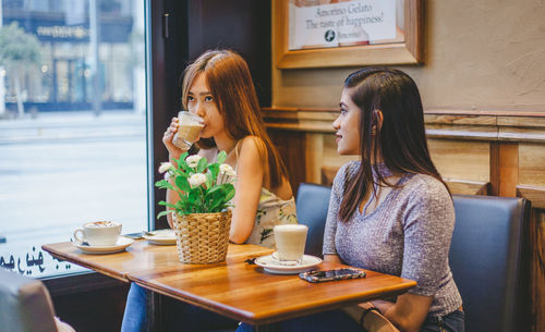 Woman sitting at restaurant table