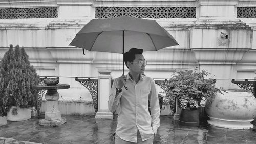 Full length of woman standing in rain