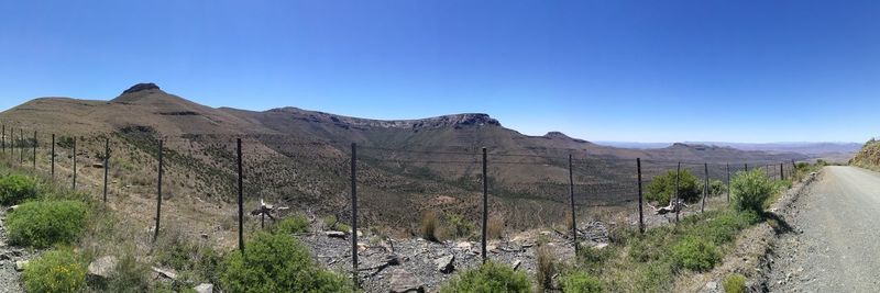 Panoramic view of landscape against clear blue sky