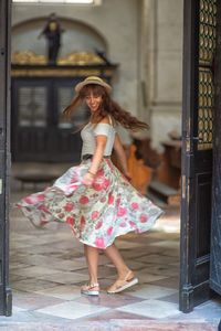 Full length of woman standing at entrance