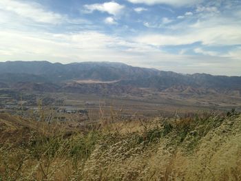 Scenic view of mountains against cloudy sky