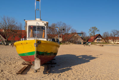 Boat on beach against clear sky