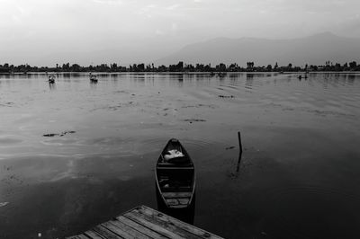 Boat moored on sea against sky