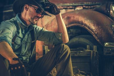 Midsection of man sitting in car