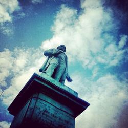 Low angle view of statue against cloudy sky