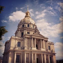 Low angle view of building against cloudy sky