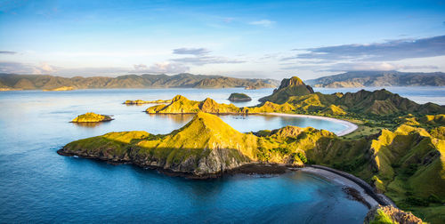 Scenic view of sea and mountains against sky