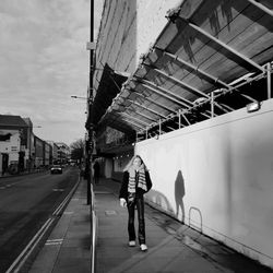 Rear view of man walking on railroad station platform