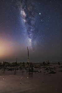 Scenic view of beach against sky at night