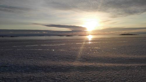 Scenic view of beach against sky during sunset