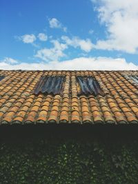 Close-up of roof tiles against sky