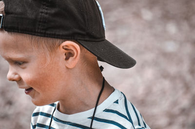 Close-up portrait of boy looking away outdoors