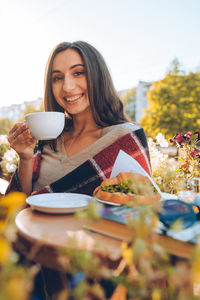 Portrait of young woman drinking coffee in cafe person