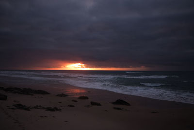 Scenic view of beach against sky during sunset
