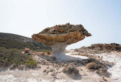 Rock formations on landscape against clear sky