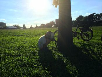 Rear view of man in farm against sky