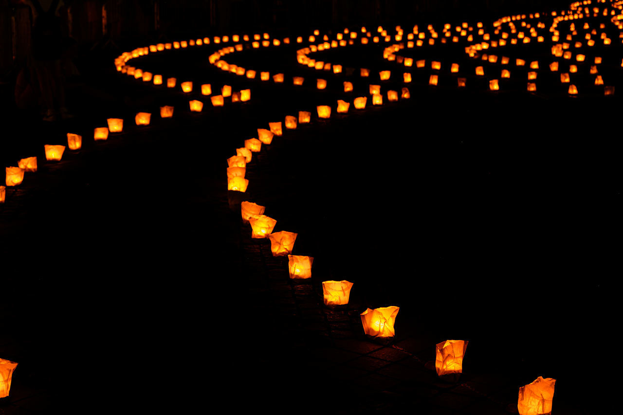 font, illuminated, night, no people, lighting equipment, darkness, large group of objects, orange color, celebration, text, in a row