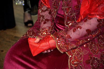 Midsection of turkish bridge sitting in wedding dress