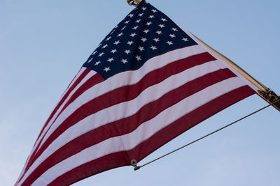 Low angle view of american flag against sky