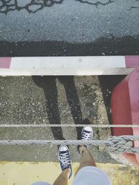 Low section of man standing on road