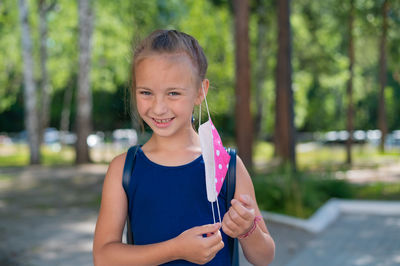 Portrait of smiling girl standing outdoors