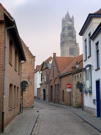 Street amidst buildings in town against sky