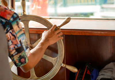 Cropped image of man steering ship