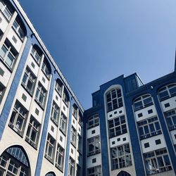 Low angle view of buildings in city against clear sky