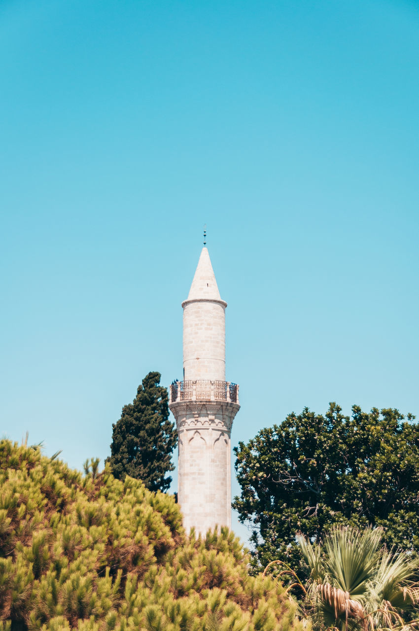 sky, tower, architecture, plant, built structure, tree, clear sky, building exterior, nature, blue, lighthouse, building, no people, travel destinations, day, copy space, travel, history, sunny, outdoors, guidance, the past, land, low angle view, landmark