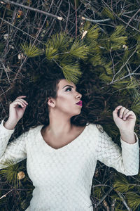 Portrait of young woman against plants