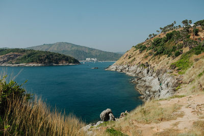 Scenic view of sea and mountains against sky