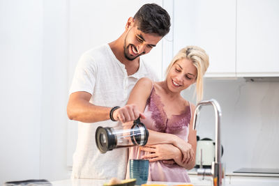 Young couple smiling at home