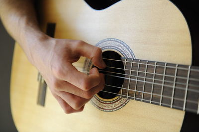 Close-up of man playing guitar