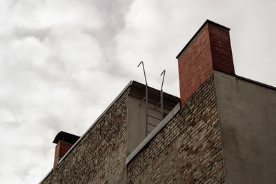 Low angle view of building against cloudy sky