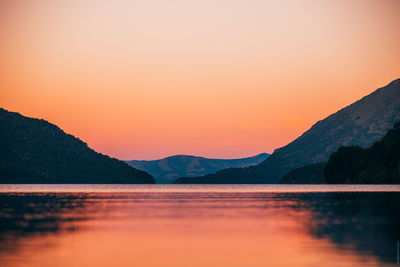 Scenic view of lake against romantic sky at sunset