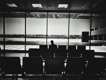 Man standing on tiled floor against sky