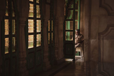 Man standing in corridor of building