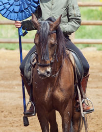 Low section of man riding horse