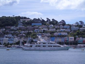 Scenic view of sea against buildings in city