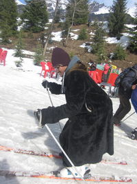 Rear view of girl standing on snow covered landscape